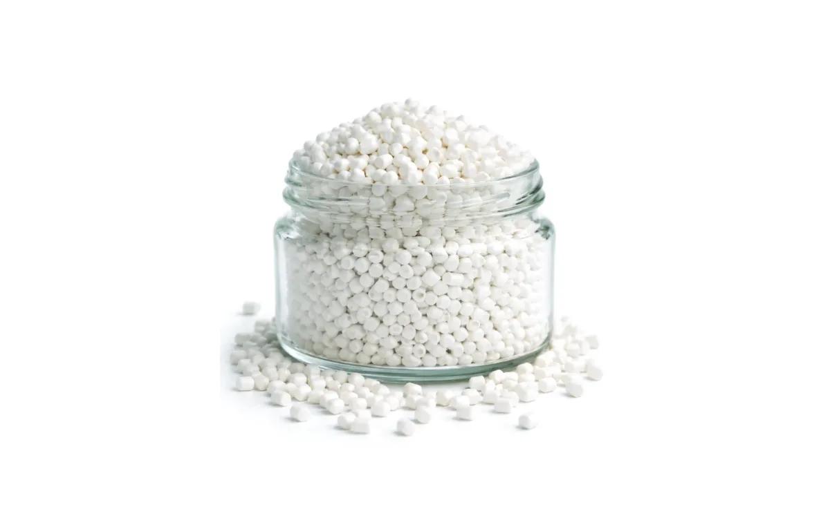 Natural polypropylene granules in a glass jar
