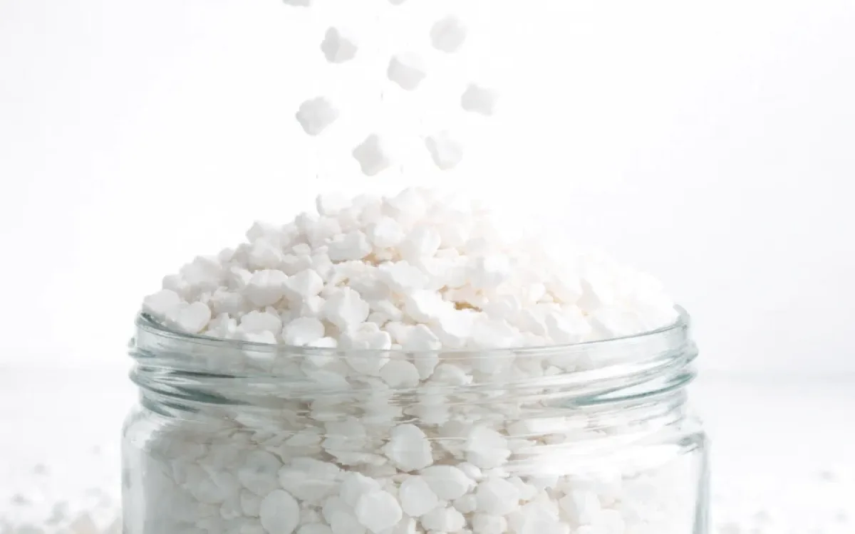Regrind polypropylene granules in a glass jar